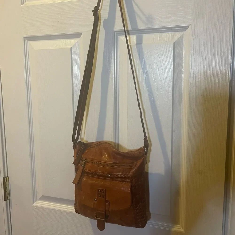 Leather tan Crossbody Bag made in India with antique studs accents.